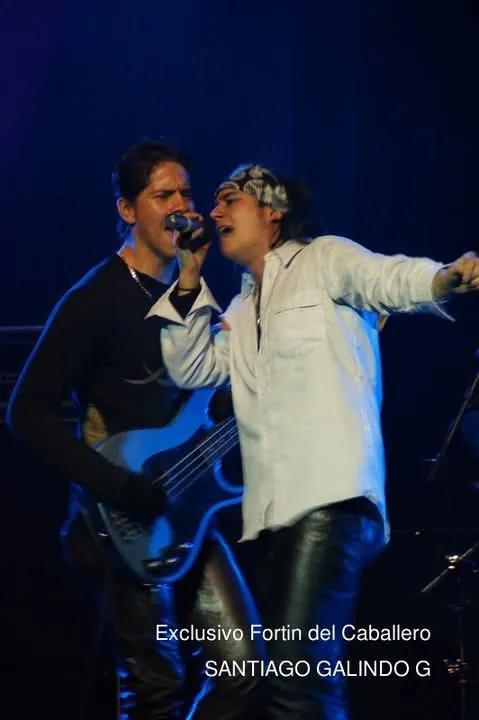 Mateo Acevedo cantando a dúo con un músico invitado durante una intensa presentación en vivo.